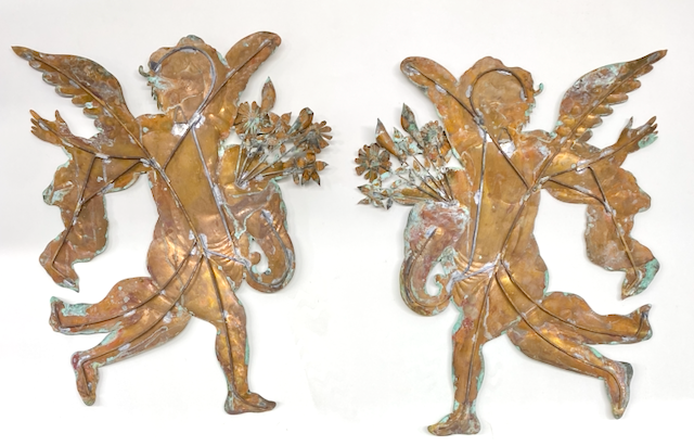 A Pair of Large Patinated Repoussé Copper Cupids