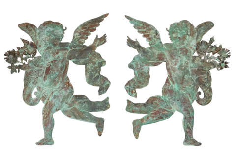 A Pair of Large Patinated Repoussé Copper Cupids